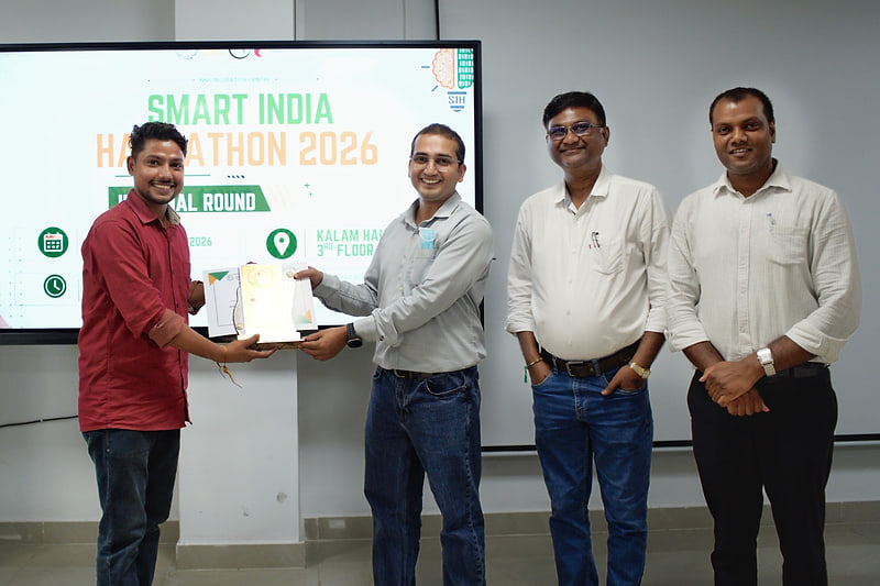 A certificate and memento being presented in Kalam Hall in front of the Smart India Hackathon 2026 slide.