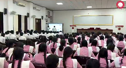 Wide view of the packed college hall during the AI Awareness Webinar.