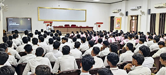 Students filling the main hall at Shri Vishwanath Inter College during the AI Awareness Webinar, with the presentation on screen.