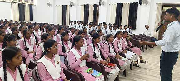 Students in the front rows listening as Atul Kumar Verma speaks from the floor of the hall.